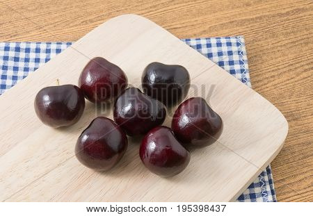 Fresh Fruits Stack of Ripe and Sweet Red Plums A Very Good Source of Vitamin C on A Wooden Cutting Board.