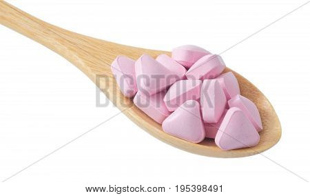 Healthcare Concept A Wooden Spoon Full with Vitamins Pills isolated on A White Background.