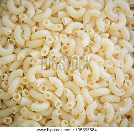 Food and Cuisine Background Textured of Uncooked and Dried Elbow Macaroni or Gomiti Pasta.
