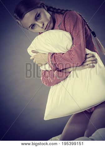 Sad Depressed Girl In Bed Gripping Pillow