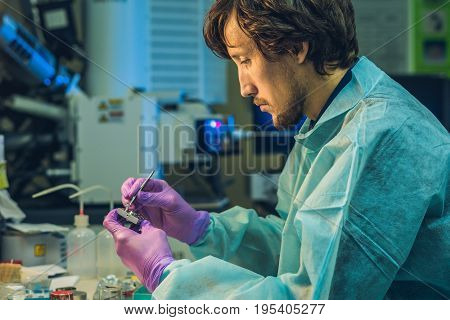 Scientist In A Laboratory Prepare A Sample For An Elecron Microscopic Investigation