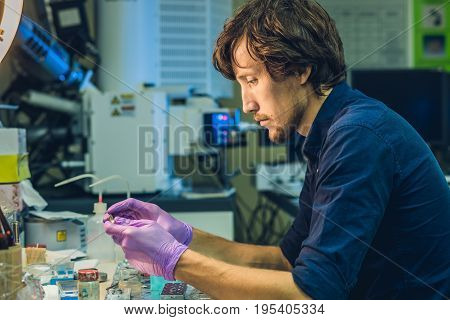 Scientist In A Laboratory Prepare A Sample For An Elecron Microscopic Investigation