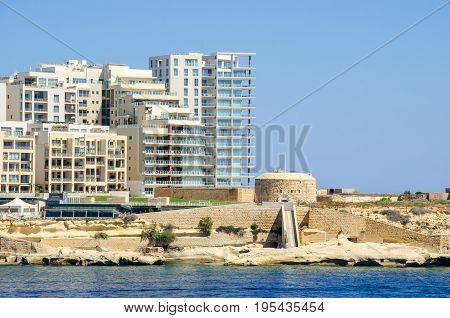 Tigne Point with Fort Tigne with its circular keep built by the Order of Saint John one of the oldest polygonal forts in the world and modern residential buildings in Sliema Malta
