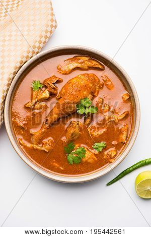 Indian spicy Chicken curry or masala chicken with prominent leg piece, popular recipe from India, selective focus