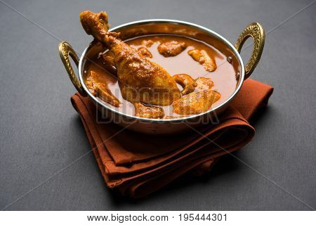 Indian spicy Chicken curry or masala chicken with prominent leg piece, popular recipe from India, selective focus