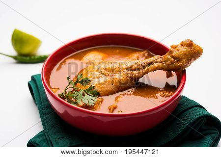 Indian spicy Chicken curry or masala chicken with prominent leg piece, popular recipe from India, selective focus