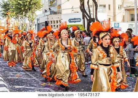 LIMASSOL, CYPRUS - FEBRUARY 26: Carnivalists in a silver cylinder hats joyfully follow the Limassol Municipality Band during the annual Carnival Parade, February 26, 2017 in Limassol.
