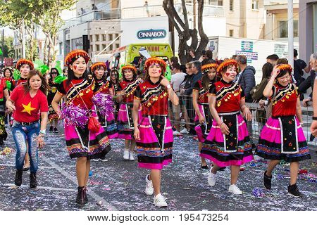 LIMASSOL, CYPRUS - FEBRUARY 26: Carnivalists in a silver cylinder hats joyfully follow the Limassol Municipality Band during the annual Carnival Parade, February 26, 2017 in Limassol.