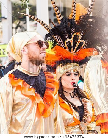 LIMASSOL, CYPRUS - FEBRUARY 26: Carnivalists in a silver cylinder hats joyfully follow the Limassol Municipality Band during the annual Carnival Parade, February 26, 2017 in Limassol.