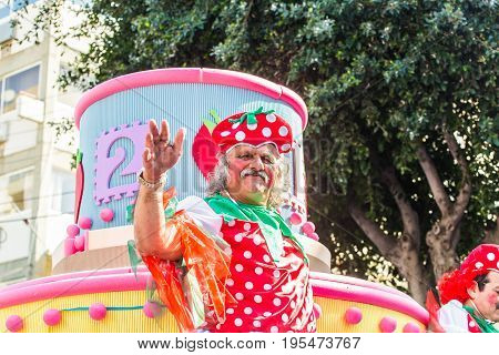 LIMASSOL, CYPRUS - FEBRUARY 26: Carnivalists in a silver cylinder hats joyfully follow the Limassol Municipality Band during the annual Carnival Parade, February 26, 2017 in Limassol.