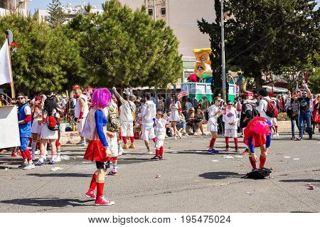 LIMASSOL, CYPRUS - FEBRUARY 26: Carnivalists in a silver cylinder hats joyfully follow the Limassol Municipality Band during the annual Carnival Parade, February 26, 2017 in Limassol.