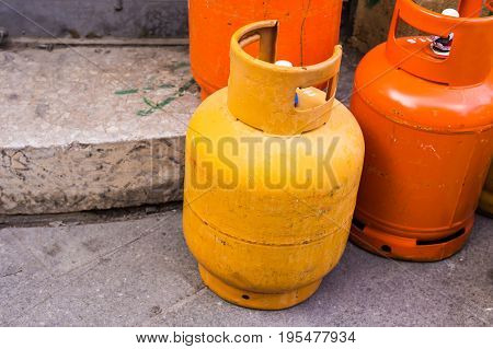 Rows of multiple red gas containers. Cooking gas cylinders.