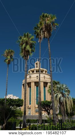 Chiesa Monumento Pantheon Dei Caduti Church behind the palm trees, Syracuse, Sicily, Italy