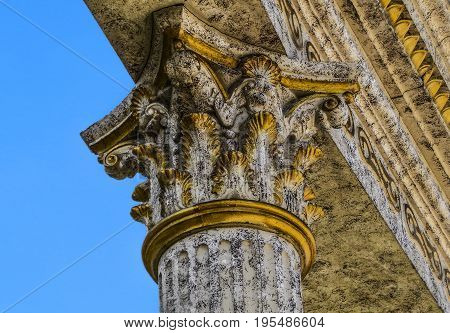 Column, closeup fragment of a column, chapiter, blue sky