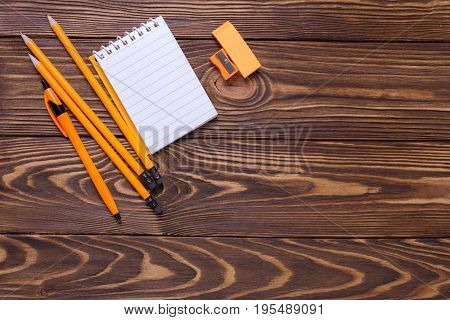 Back to school. Pencils pen note erazer on wooden background. Top view. Place for text.