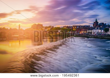 The River Nith and old bridge at sunset in Dumfries Scotland UK.