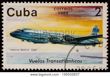Moscow Russia - July 14 2017: A stamp printed in Cuba shows passenger airliner Douglas DC-4 Airline Havana-Madrid (1948) series 