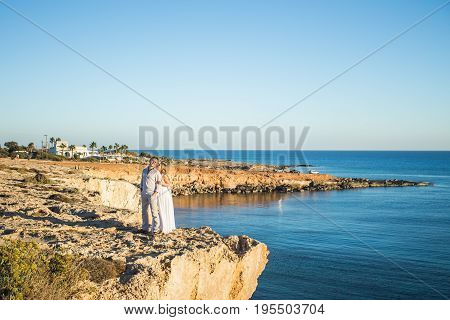 Romantic dating. Young loving couple walking together by the beach enjoying sea.