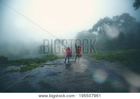 Lover Men and women Asia travel relax. walk in the forest rainy season. puhinrongkla Thailand