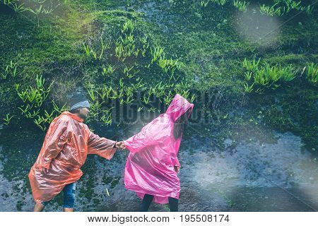 Lover Men and women Asia travel relax. walk in the forest rainy season. puhinrongkla Thailand