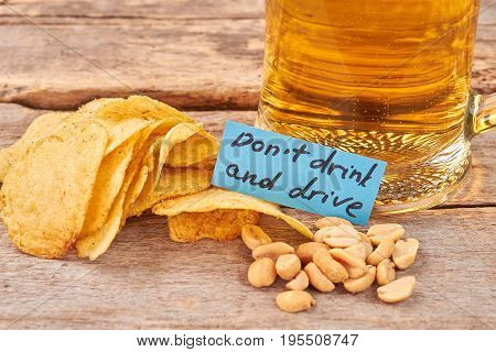 Do not drink and drive concept. Beer background, paper message.
