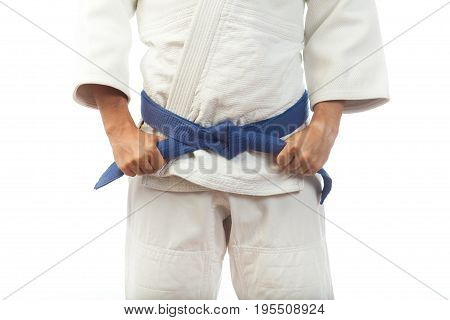 Close-up Of A Man  In A White Kimono For Judo, Ties Up A Blue Belt