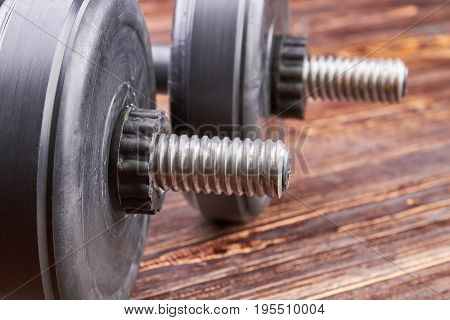 Close up of two metal dumbbells. Heavy object for fitness in gym.