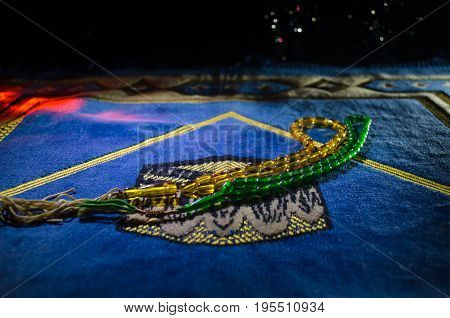 Holy Quran With Beads On A Prayer Mat, Muslim Tasbih Is A String Of Prayer Beads Which Is Traditiona
