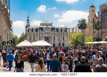 SANTIAGO CHILE - OCTOBER 23 2016: People walking on Plaza de Armas with Central Post Office Building (Correo Central) on the background. This is a historic house and a famous touristic attraction.