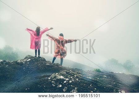 Lover Men and women Asia travel relax. walk in the forest rainy season. puhinrongkla Thailand