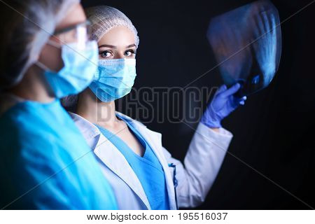 Medical team speaking of a X-ray in an operating room. Doctor. X-ray
