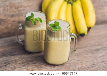 Banana Smoothies And Bananas On An Old Wooden Background