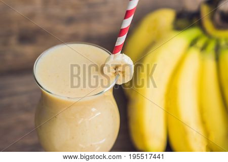 Banana Smoothies And Bananas On An Old Wooden Background
