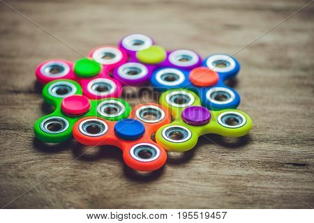 Colored Fidget Spinners Stress Relieving Toy On Wooden Background