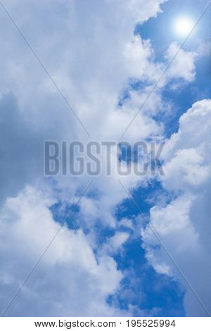 View on beautiful white Clouds on a blue Sky. Close-up of a cloudy Sky. The Sun is shining from a blue Sky