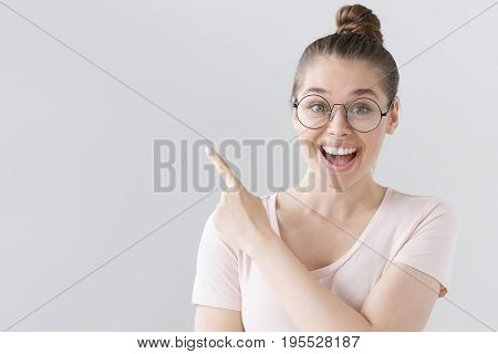 Horizontal Picture Of Young Good-looking Female Isolated On Grey Background Wearing Big Round Specta
