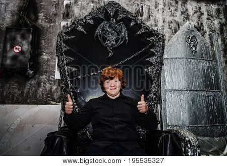 Red-haired Boy Sitting On The Magic Throne