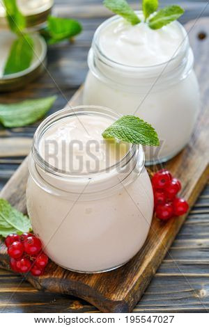Sour Baked Milk And Natural Yoghurt In Glass Jars.
