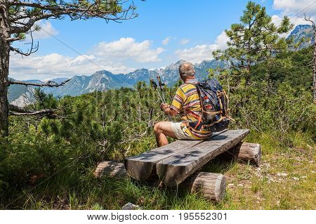 Hiker About 60 Years Old Watching The Alpine Panorama.