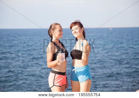 Two Girls After Sports And Fitness On The Beach 1