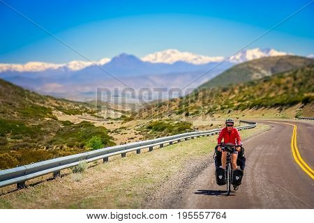 Woman cycling on the famous national Ruta 40 
 quarenta in central Argentina