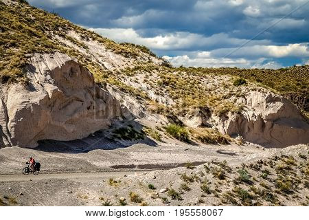 Woman cycling on the famous national Ruta 40 quarenta in the remote part of central Argentina