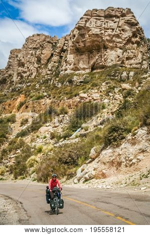 Woman cycling on the famous national Ruta 40 quarenta in the remote part of central Argentina
