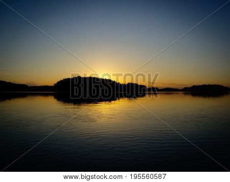 Dark orange Sunset over a finnish lake