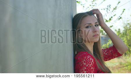 sexy girl. serious stands sexy girl near barrel oil petrol . An oil old barrel