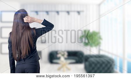 Young Beautiful Business Woman And Creative Designer Standing Over Blured Interior Background