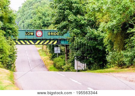 Day view of UK motorway highway under railway bridge.