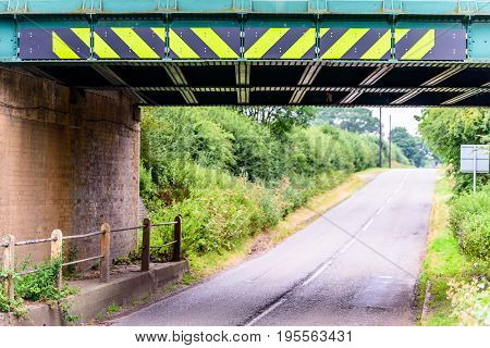 Day view of UK motorway highway under railway bridge.