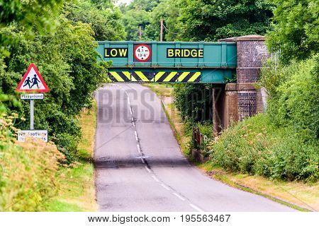 Day view of UK motorway highway under railway bridge.