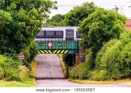 Day view of UK motorway highway under railway bridge.